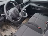 the interior of a small car with a steering wheel and dashboard