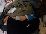 a bag full of clothes and other items in it