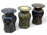 three different colored vases sitting next to each other on a white surface