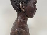 an image of a statue of a young boy with a black hair