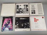 six beatles albums, including the beatles first album, are on a table