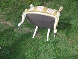 a chair that is sitting in the grass on the ground