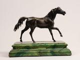 bronze statue of a horse on a marble base