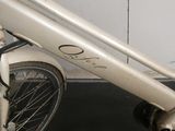 a close up of a bicycle parked in front of a wall