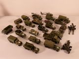 a lot of military vehicles that are on a white surface