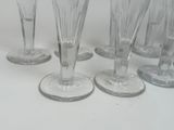 several empty wine glasses sitting on top of a white table
