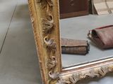 a mirror that is sitting on the floor next to a purse