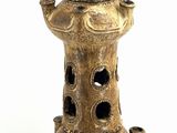 a picture of a tall vase with a bird on top of it