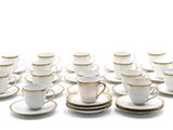 a lot of cups and saucers sitting on a table