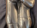 a silver statue of a man holding a woman ' s hand