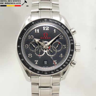 a close up of a watch with a black face