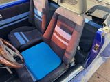 two seats in the back of a car with a steering wheel