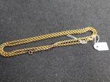a close up of a gold chain with a tag on it