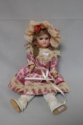 an image of a doll is sitting on a white surface