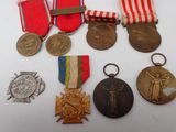 several medals and medals are displayed on a white surface