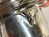 a person holding a silver object in their hand