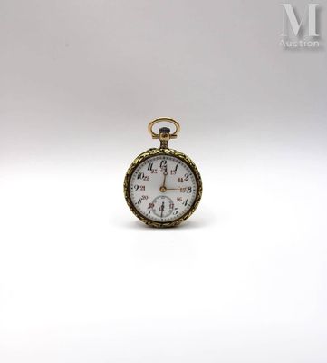 a close up of a pocket watch on a white surface