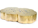 a close up of a gold coffee table with blue dots on it
