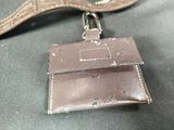 a brown leather purse with a keychain attached to it