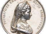 a close up of a coin with a woman ' s head on it