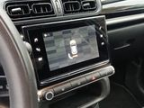 the interior of a car with a steering wheel and a touch screen