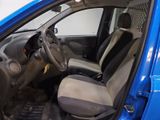 the interior of a small blue car with a steering wheel