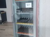 a coca cola cooler that is on display in a room