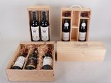 three bottles of wine in a wooden box on a table