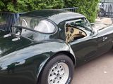 a green sports car parked on the side of the road