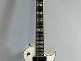 an electric guitar sitting on top of a white table