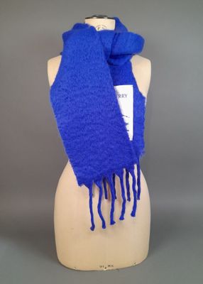 blue scarf with fringes on mannequin head on display