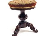 a small wooden stool with a cushion on top of it