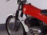 a red and white motorcycle parked in a garage