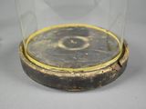 a glass jar with a gold rim on a table