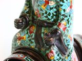 a close up of a vase with a horse on it ' s head