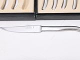 a knife that is sitting in a box next to a knife