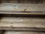 a wooden shelf that has two shelves on it