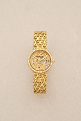 an image of a gold watch on a white surface