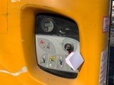 a yellow parking meter with a paper attached to it