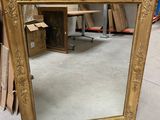 a mirror that is sitting on the floor in a room