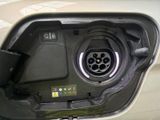a close up of a car ' s fuel tank with a car plugged in