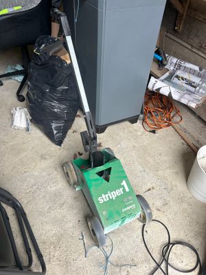 a machine that is sitting on the floor next to a trash can