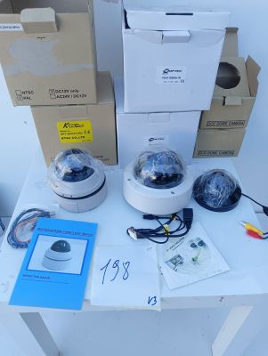 two cameras sitting on top of a table next to boxes