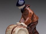 an image of a figurine of a man sitting on a barrel