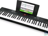 a small electronic keyboard with a tablet on it