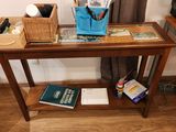 a small table with a book and a bag on it