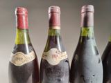 three bottles of wine are lined up on a table