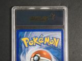 the pokemon trading card is in a plastic holder on a table