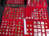 a lot of coins in a red box on a table