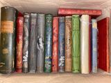 a box full of old books sitting on a table
